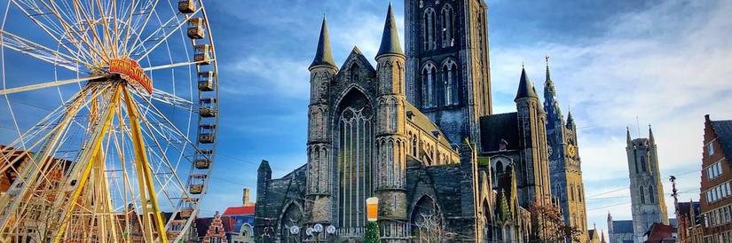 Old cathedral in Belgium with Ferris wheel to the side
