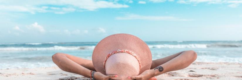 Shot of a woman sunbathing on the beach in Playa del Carmen