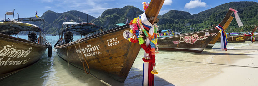 Tourist boats on a beach in Ko Phi Phi, Thailand